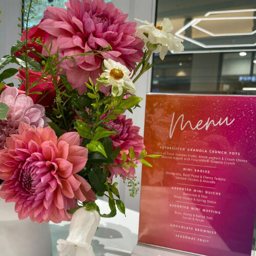 9 Yard Marketing - Decor and Florals 9 Yard Marketing event décor with floral arrangements and branded signage.
